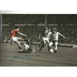 Autographed Sammy Mcilroy photo, a superb image depicting McIlroy slipping the ball under Arsenal