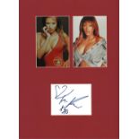 Traci Bingham signature piece. Mounted below 2 colour photos. Approx overall size 16x12. Good