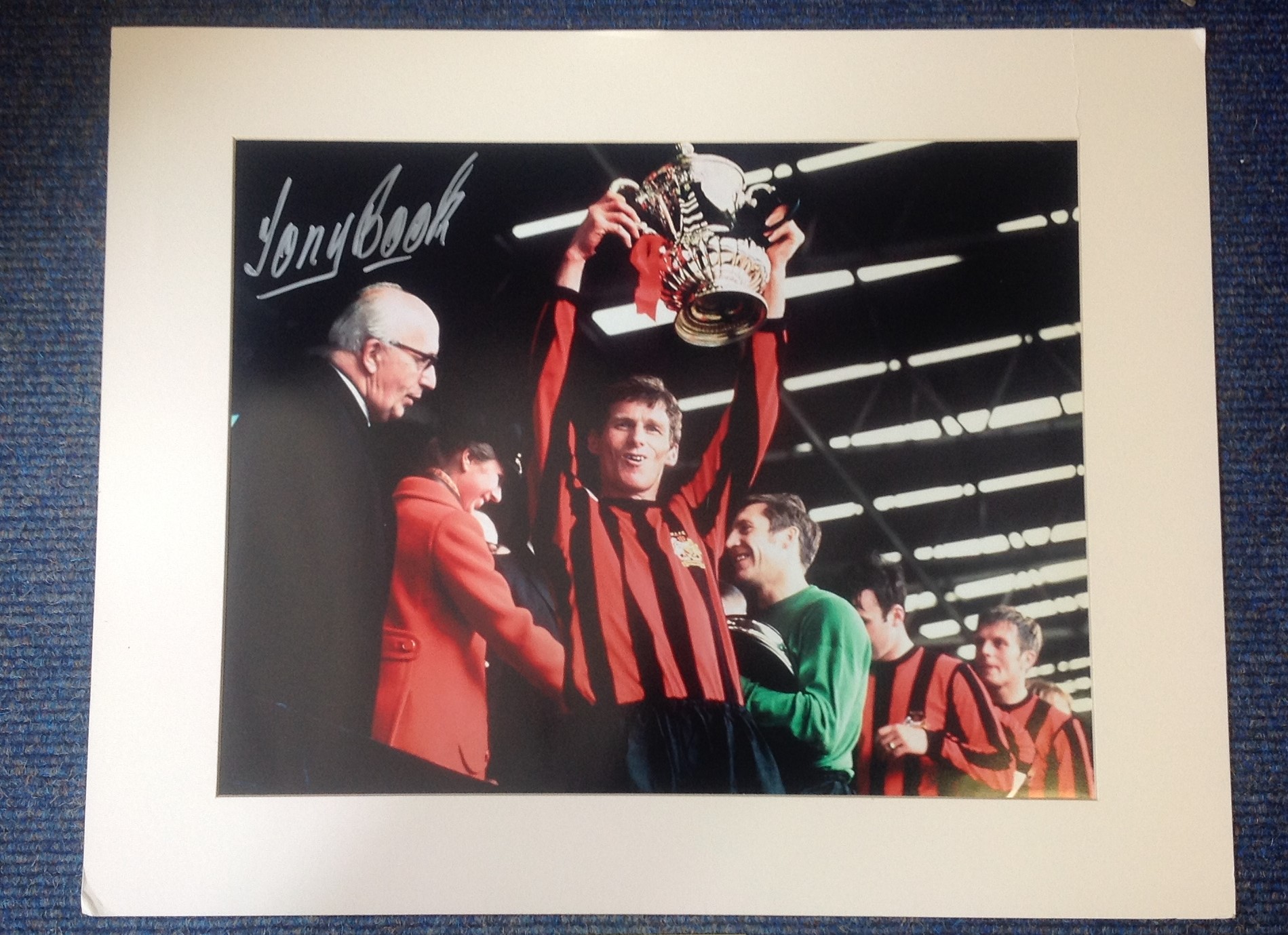 Tony Book signed colour photo with the FA cup for Man City. Mounted to approx size 20x16. Good