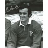 Phil Bennett signed 10x8 b/w photo pictured in Wales kit. Good Condition. All signed pieces come