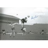 Autographed DENIS LAW photo, a superb image depicting the Scotland forward rising high to get to the