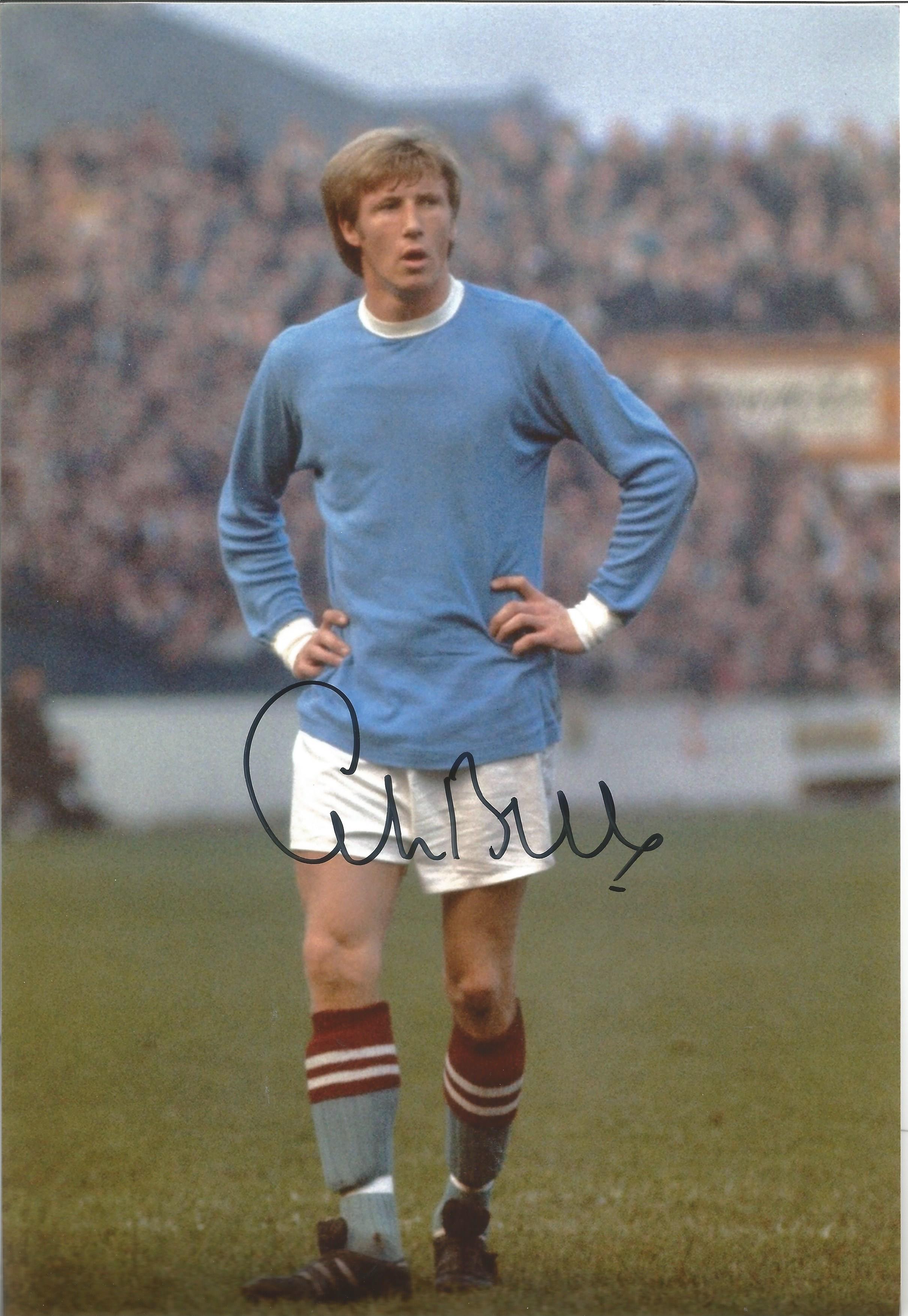 Colin Bell signed 12x8 colour football photo pictured in action for Manchester City. Good Condition.