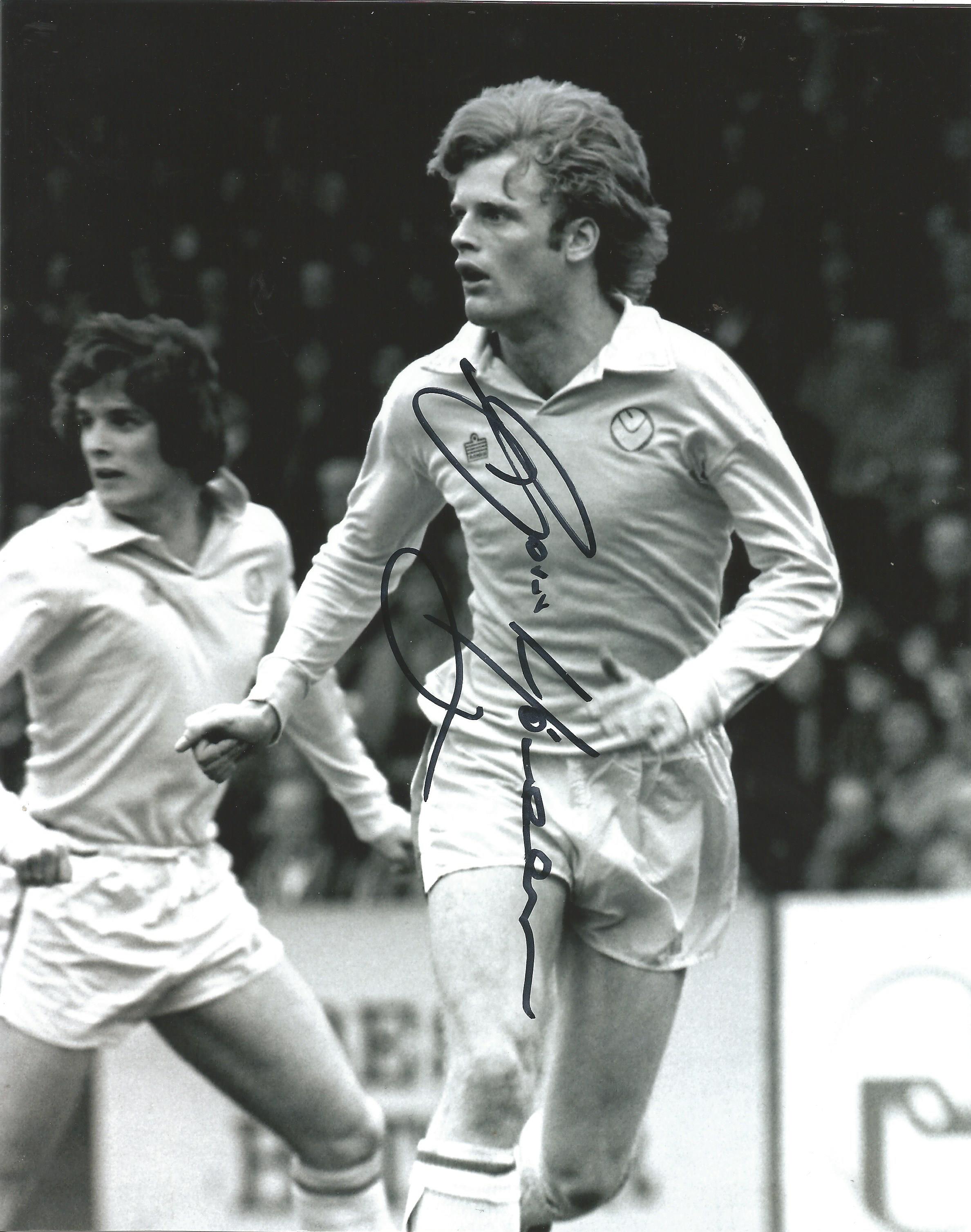 Gordon McQueen signed 10x8 b/w football photo pictured in action for Leeds United. Good Condition.