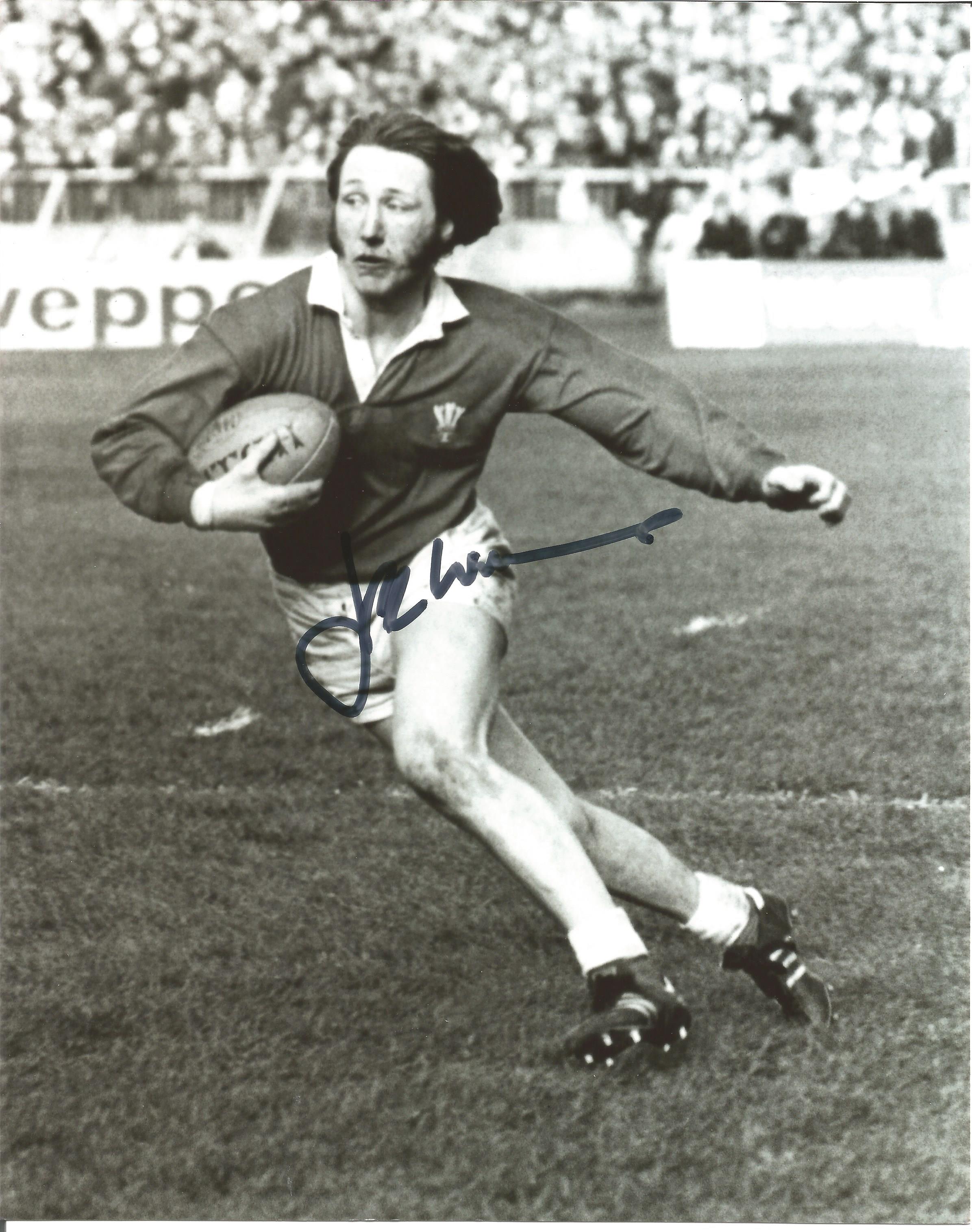 Rugby J.P.R Williams signed 10x8 b/w photo pictured in action for Wales. Good Condition. All