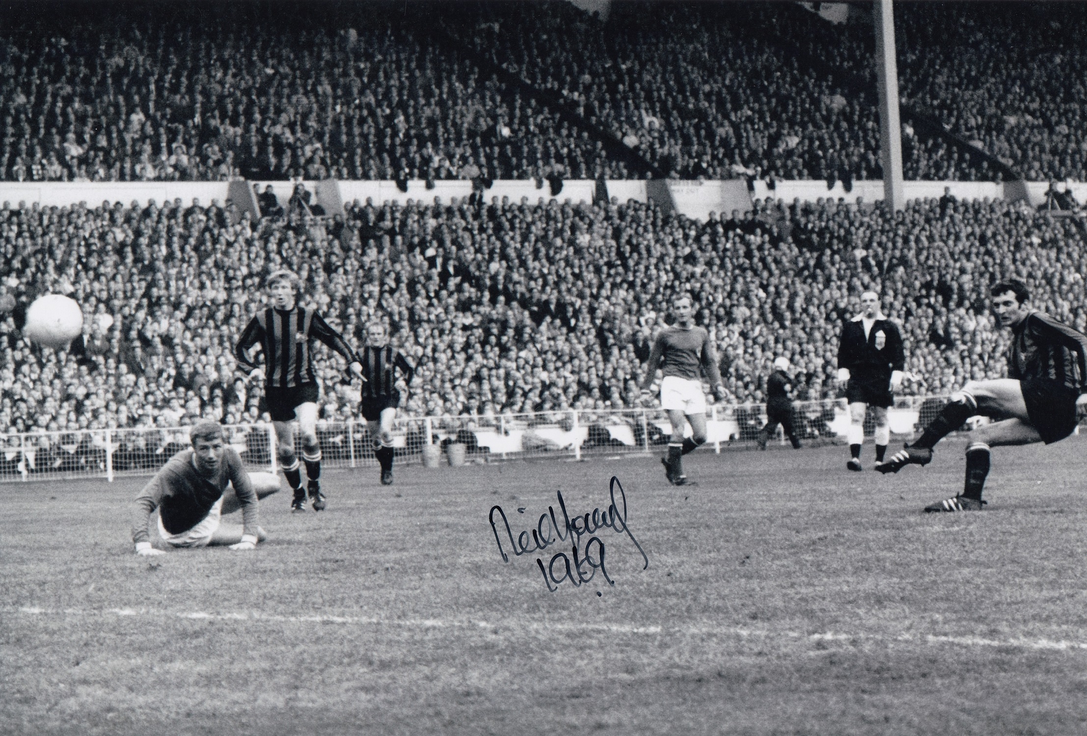 Football Autographed NEIL YOUNG photo, a superb image depicting the Manchester City centre-forward