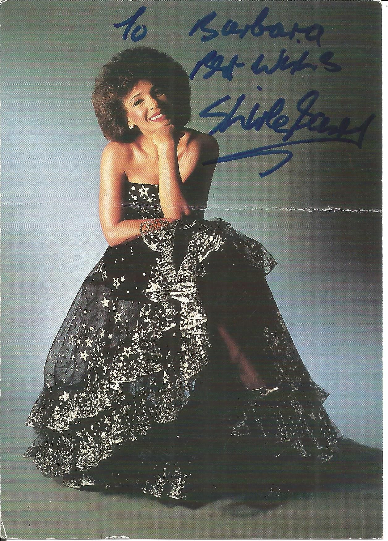 Shirley Bassey signed 6 x 4 inch colour photo. Slight fold mark. Dedicated. Good Condition. All