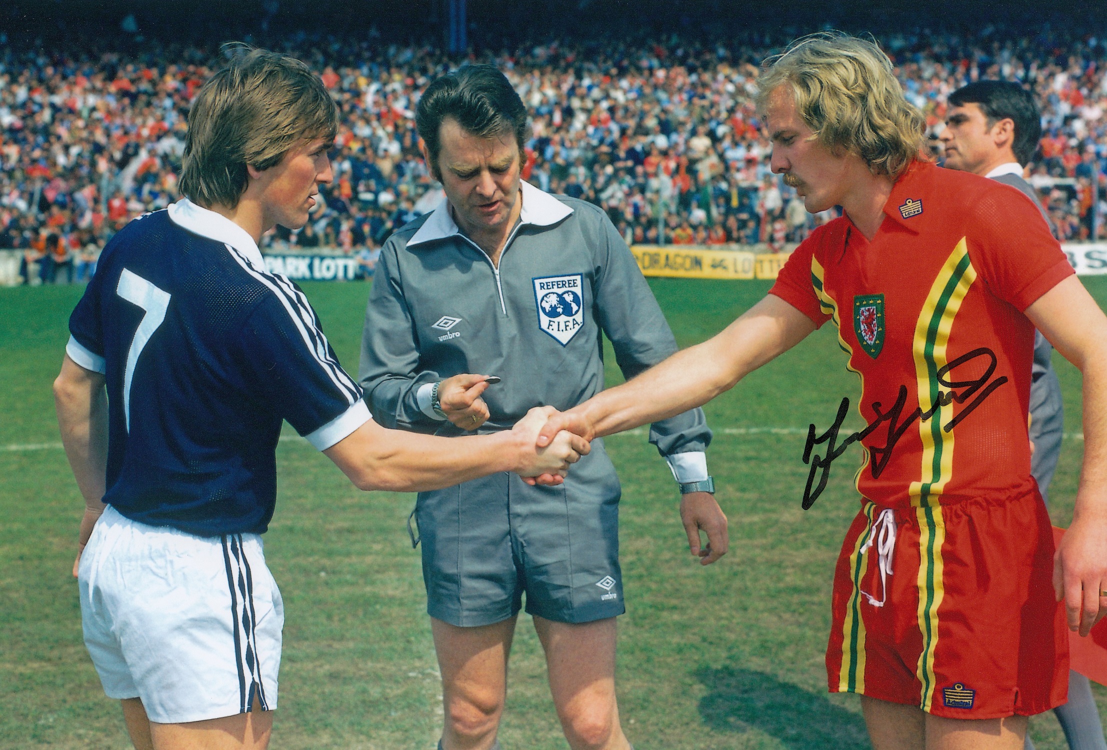 Football Autographed TERRY YORATH photo, a superb image depicting the Welsh captain shaking hands