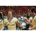 Football Autographed JIM STEELE photo, a superb image depicting Steele celebrating with the FA Cup