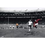 Football Autographed GEOFF HURST photo, a superb image depicting Hurst scoring his third goal and