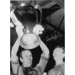 Football Alex Stepney 16x12 signed black and white photo pictured celebrating with Manchester United