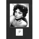 Joan Collins signature piece, mounted below b/w photo. Approx. overall size 16x12. Good Condition.