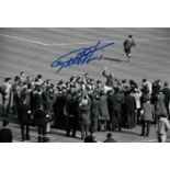 Football Autographed Geoff Hurst Photo, A Superb Image Depicting England Captain Bobby Moore Holding