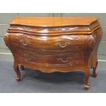 A Continental bombe commode, of serpentine outline with two short and two long drawers 84 x 115 x