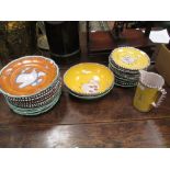 An Italian pottery dinner service, painted to the centre with animals on yellow and orange grounds