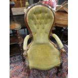 A Victorian button upholstered open arm easy chair with foliate carved and showwood frame, scroll