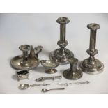 A collection of silver plated items including a pair of candlesticks and a chamberstick, and three