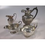 A silver hot water jug, two sauce boats and a cream jug 24oz