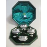 A cased set of four Victorian silver salts with blue glass liners Birmingham 1894, and