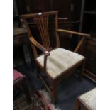 An early 19th century fruitwood carver armchair with paper scrolled top rail with pierced vase splat