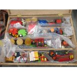 Britains; unboxed plastic and die-cast tractor and agricultural models in a scratch built wooden