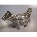 A German silver cow creamer by Johann S Kurz & Co, stamped with the Reichsmark and '925' 19cm long