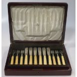 A set of six silver teaspoons with berry finials cased by Harrods together with two other sets of