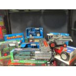 A Teamsterz 4x4 and livestock trailer, boxed, An ERTL Ford 8630 Tractor, boxed, and another, A die-