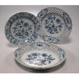 An assortment of Meissen onion pattern plates to include two shaped circular plates and an oval dish