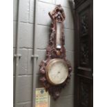 A late Victorian oak cased barometer carved with fruit and berries