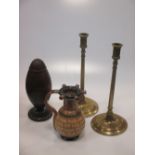 A lignum vitae spice grinder, a pair of brass candlesticks and a Doulton puzzle jug (4)