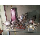 A collection of silver plated ware including a teapot and coffee pot