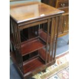 An Edwardian walnut revolving bookcase, 85 x 48sq cm