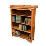 An Arts and Crafts oak bookcase in the manner of Liberty's, the cresting panel with central 'ying