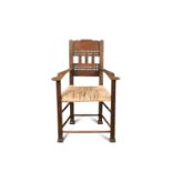 A Continental oak rush seated armchair, the shaped back with pierced and carved decoration, the