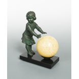 An Art Deco table lamp, modelled as a bronzed spelter girl warming her hands on the glass globe,