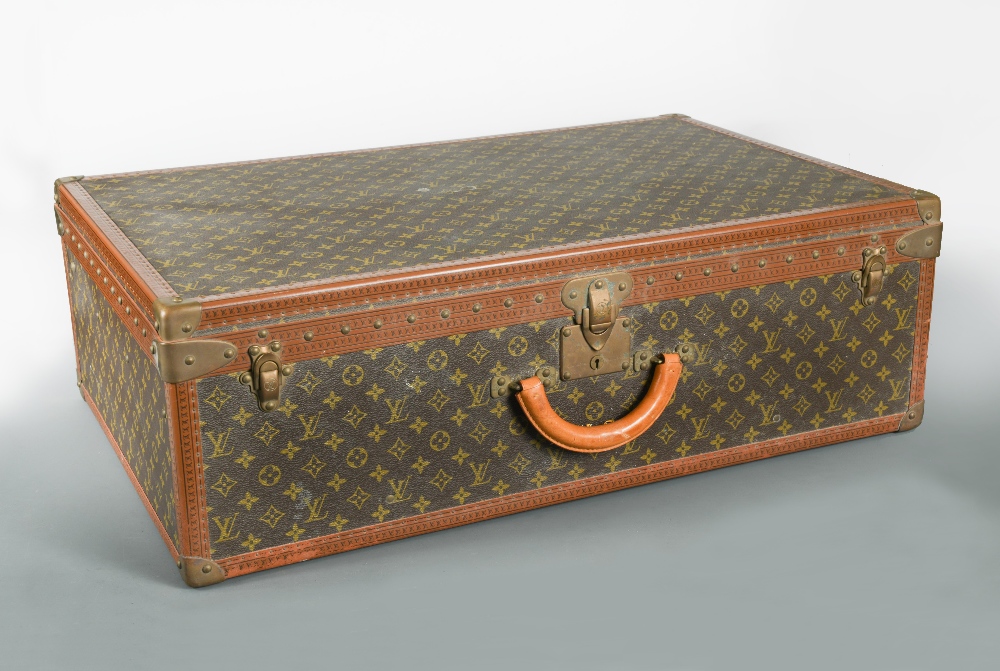 Louis Vuitton, a large monogrammed canvas and leather suitcase, late 20th century, opening to reveal