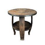 An Arts and Crafts oak table, of barrel form with circular, iron-bound top, undertier and bowed legs