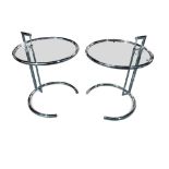 After Eileen Gray, a pair of E1027 adjustable side tables, the glass tops with chromed tubular