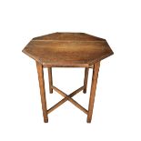 A Cotswold School oak occasional table, the octagonal top on four chamferred legs united by an X-