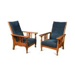 A pair of Arts and Crafts oak framed reclining chairs, possibly by Shapland & Petter, the adjustable