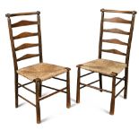 Attributed to C. R. Ashbee for the Guild of Handicraft, a pair of rush seated ladder back chairs,