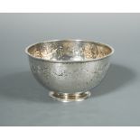 A small silver footed bowl by Liberty & Co., Birmingham 1919, the repoussé circular bowl decorated