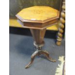 A Victorian walnut sewing table of octagonal tapering form, on a tripod base, 71cm high
