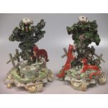 A pair of Continental 19th century candlestick bases, modelled on stories from Aesop's fables,