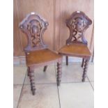 A pair of Victorian oak hall chairs