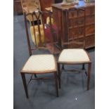 A pair of Edwardian mahogany stick back chairs with mother of pearl and lightwood inlay and