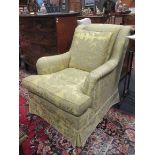 A modern armchair in yellowed green damask fabric