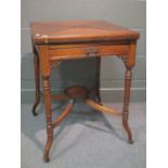 An Edwardian walnut envelope card table