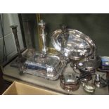 A large quantity of silver plated ware including candlesticks, an entree dish with cover, some cased