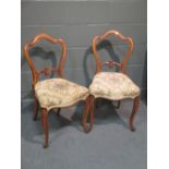 A set of four walnut dining chairs